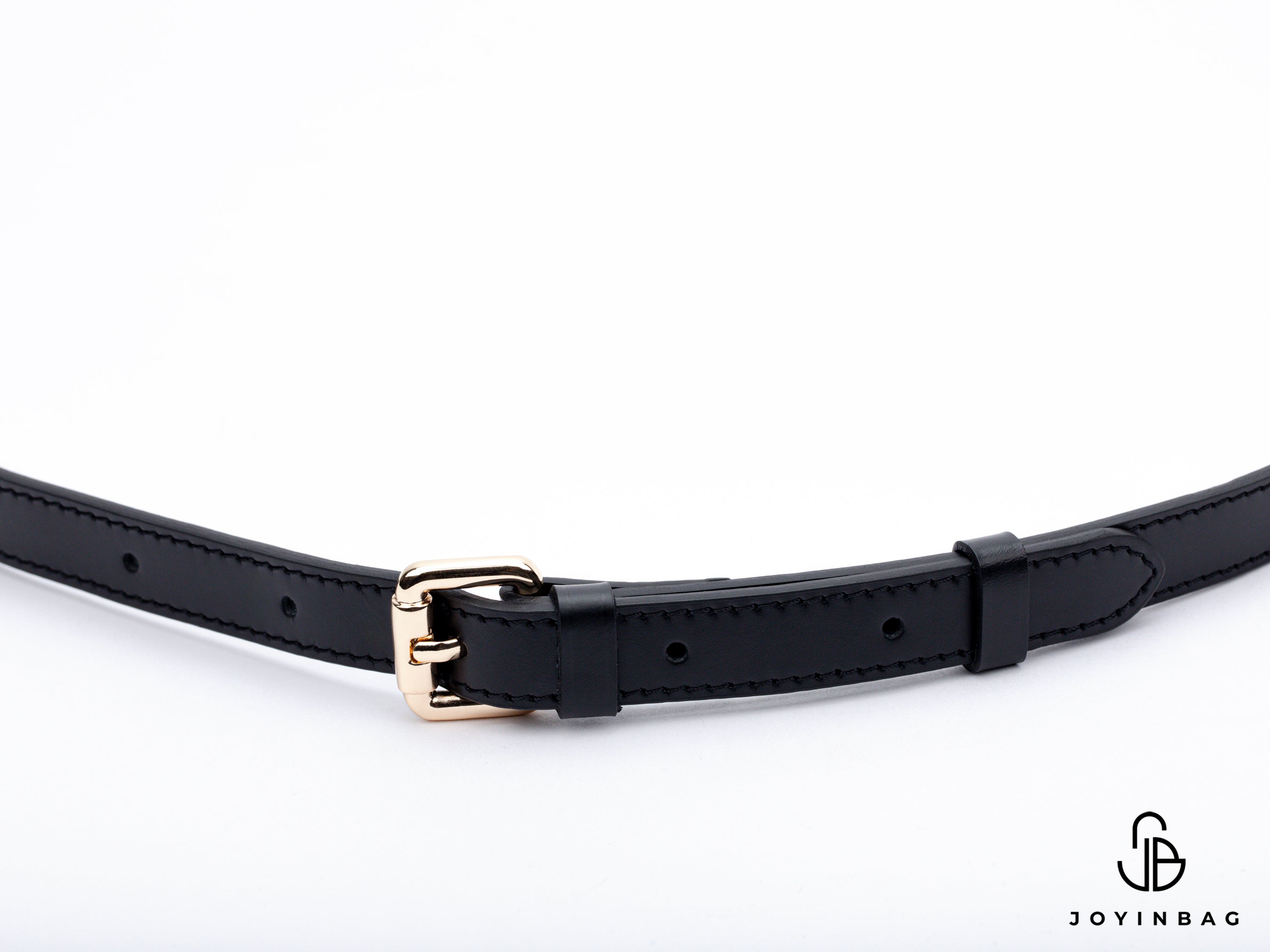 Adjustable black vachetta strap with clasp closure at both ends.