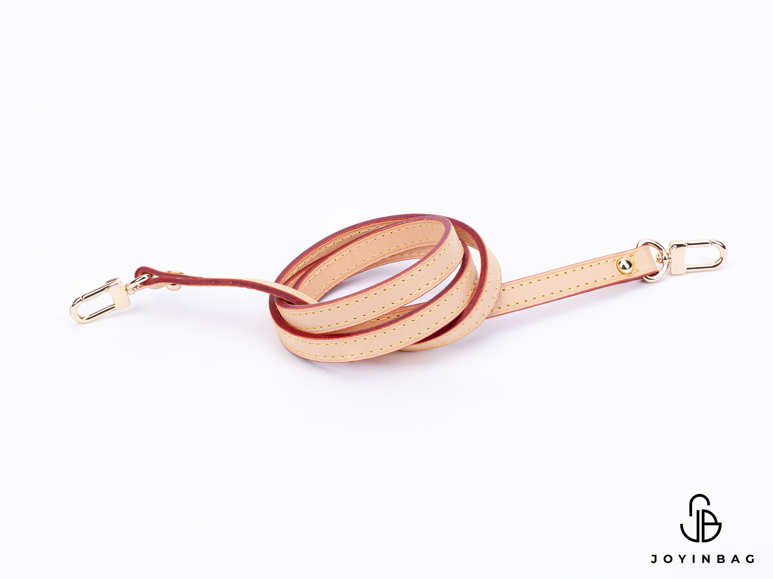 Natural vachetta strap with clips on both ends.