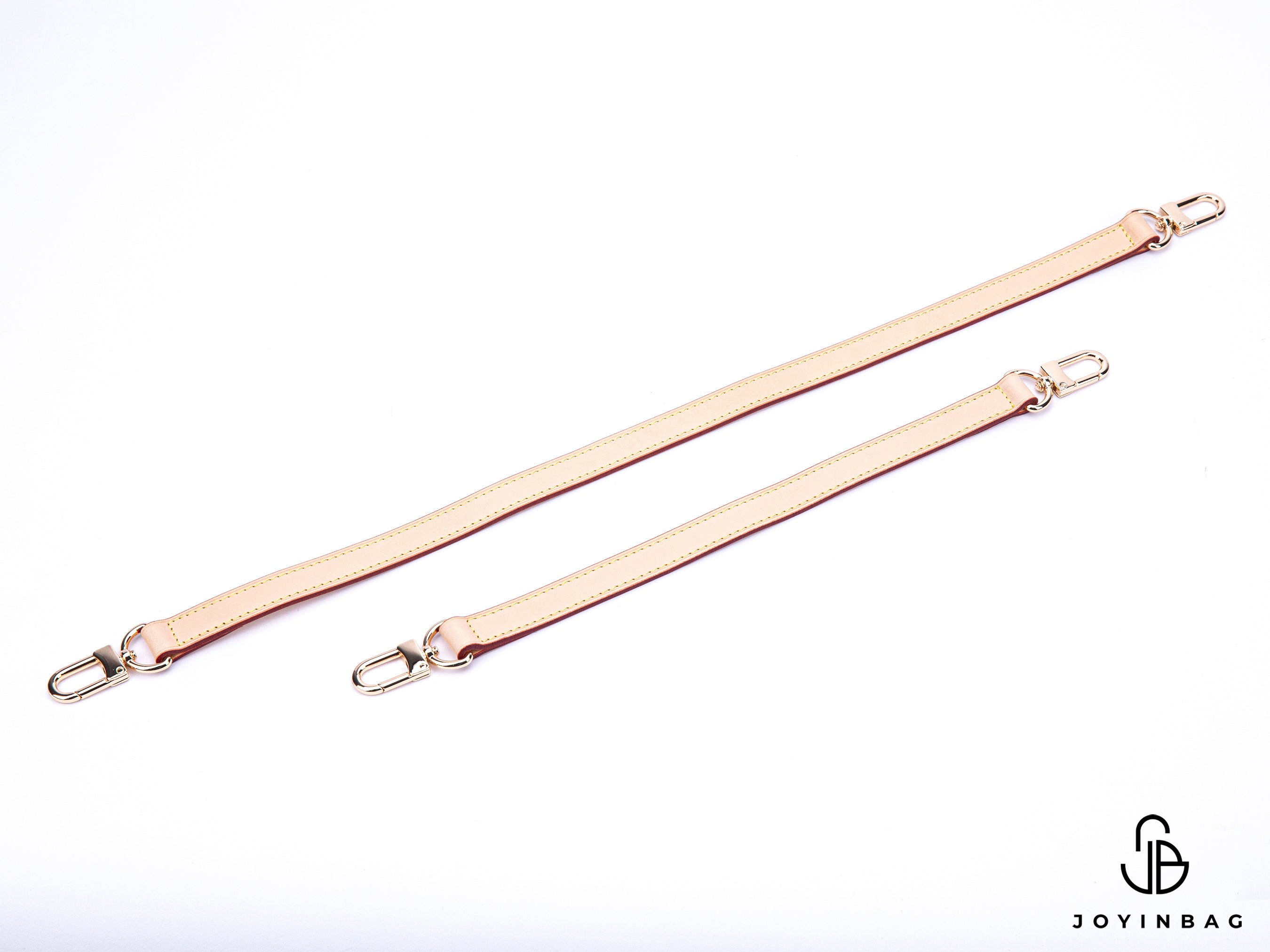 A gold or silver leather strap in natural vachetta replaces the bag's shoulder or hand straps.