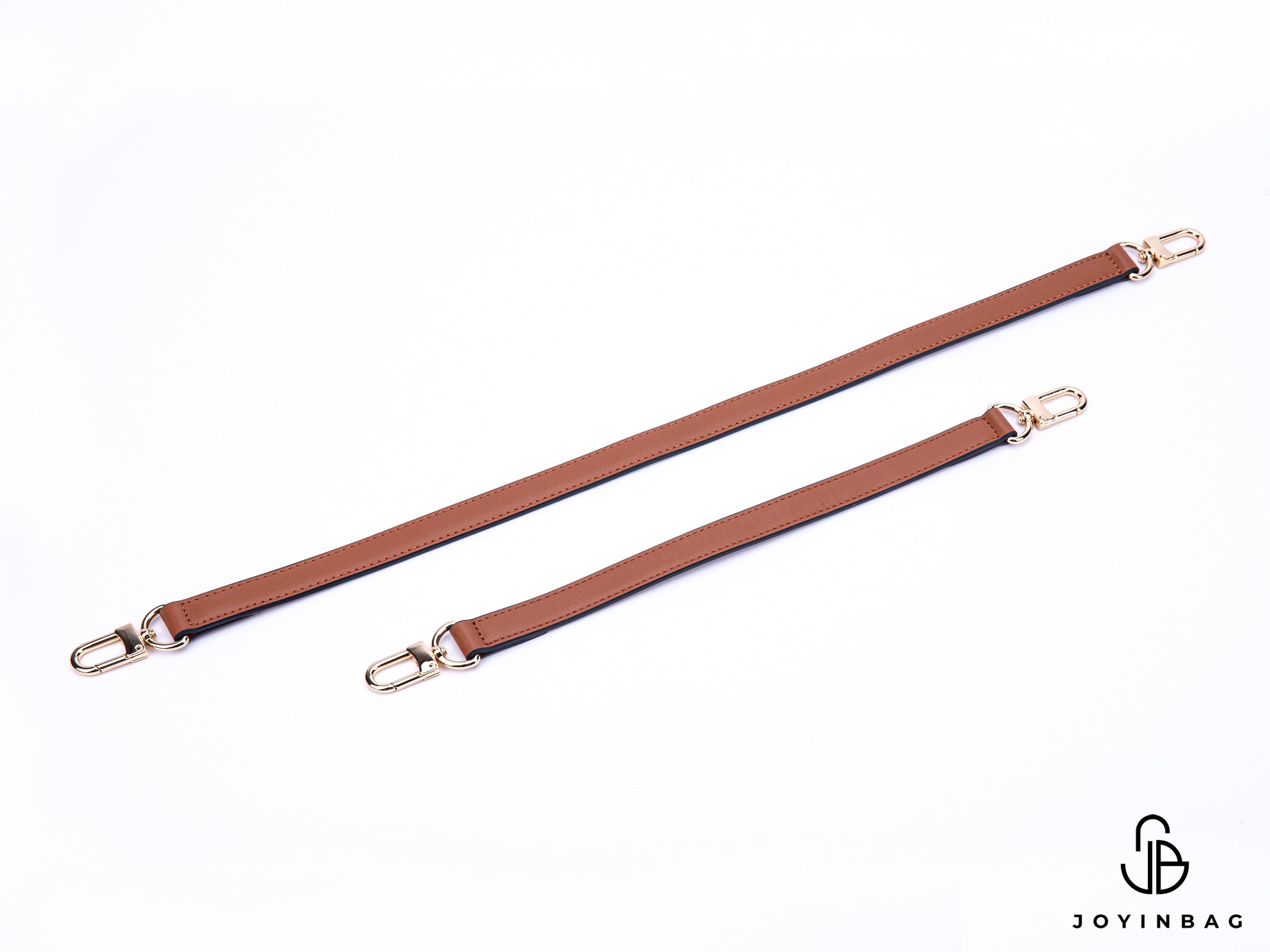 A gold or silver leather strap in a brown vachetta color replaces the bag's shoulder or hand straps.