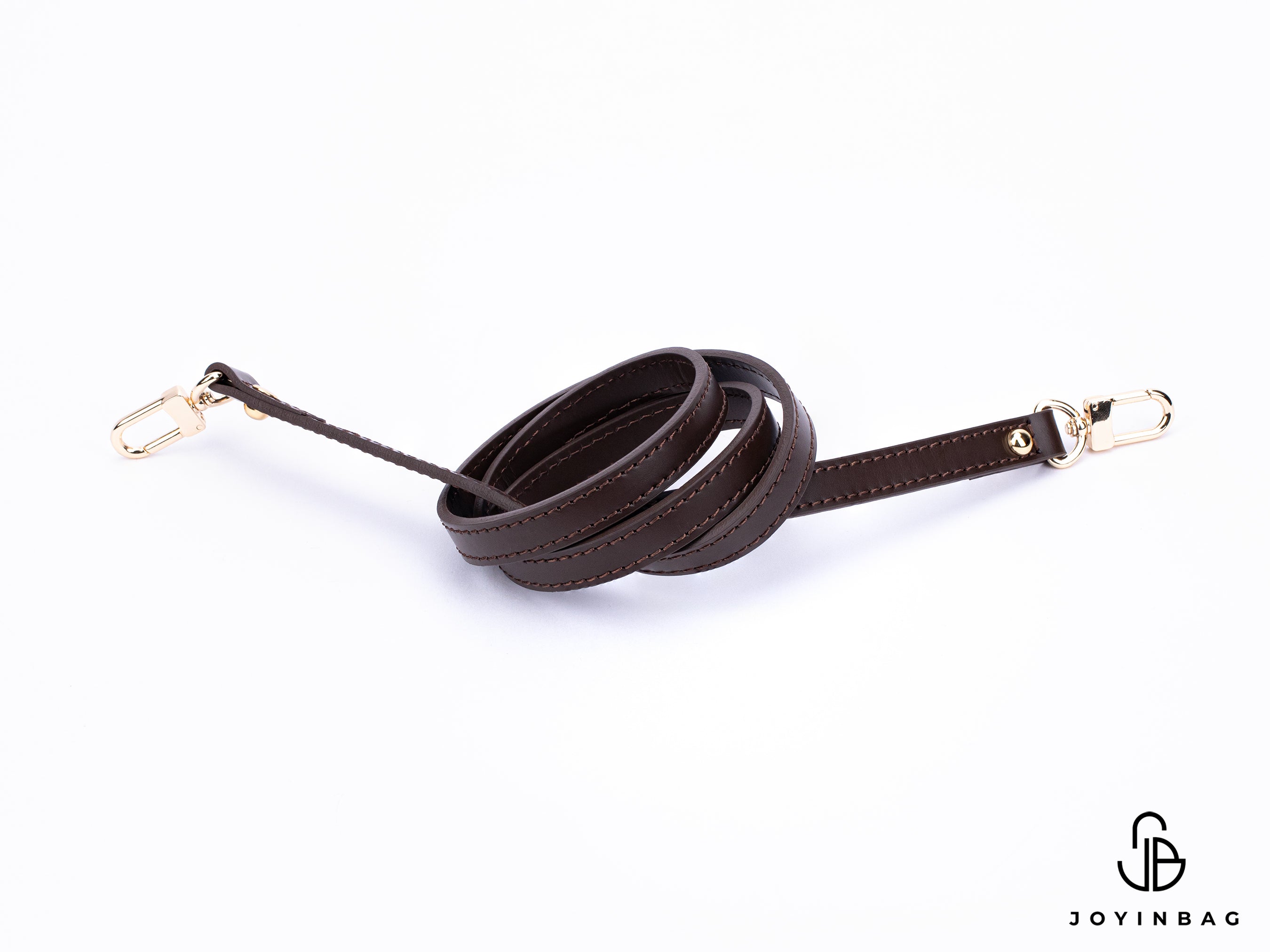 Dark brown vachetta strap with clips on both ends.