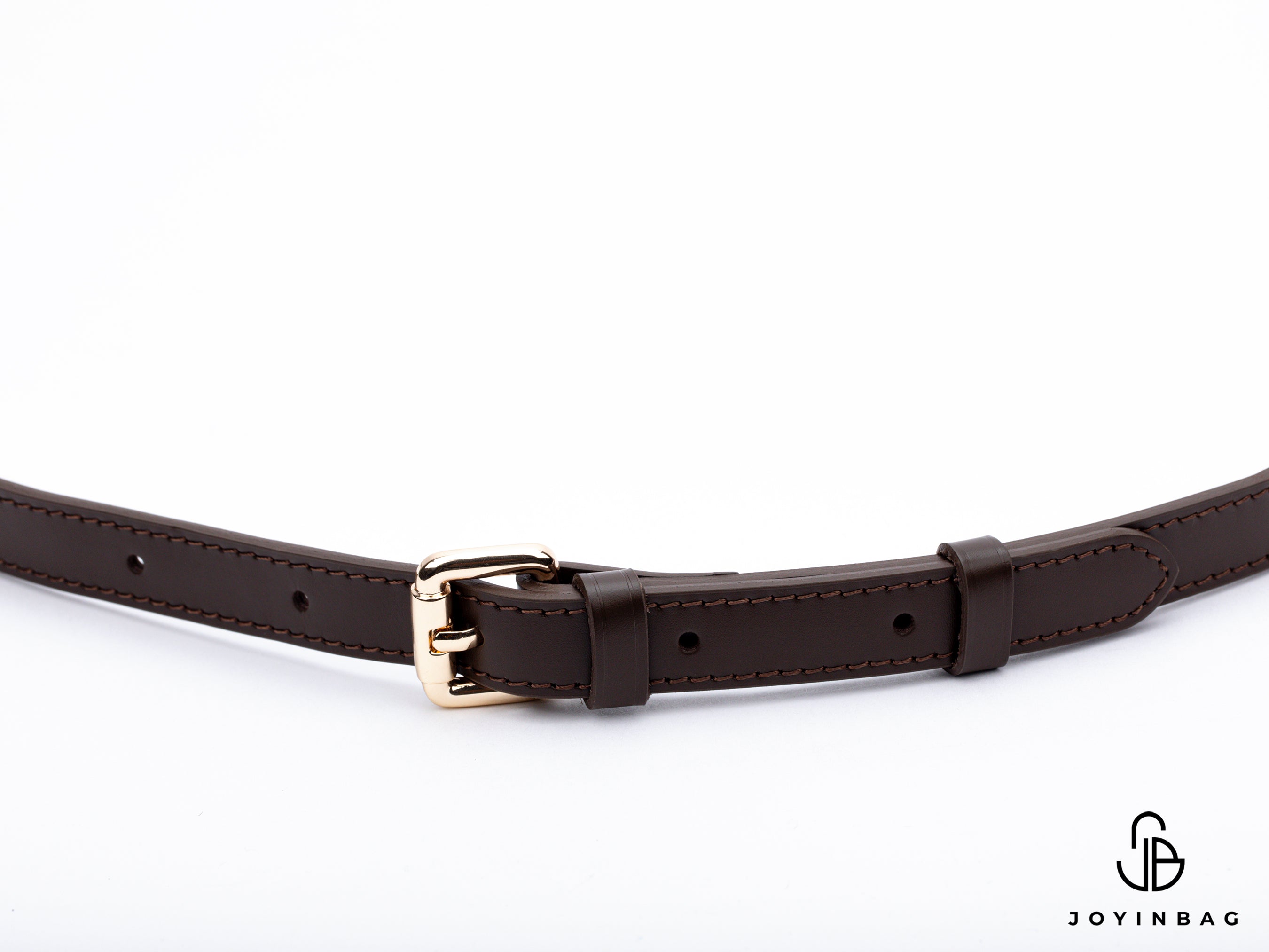 Adjustable dark brown vachetta strap with clasp closure at both ends.
