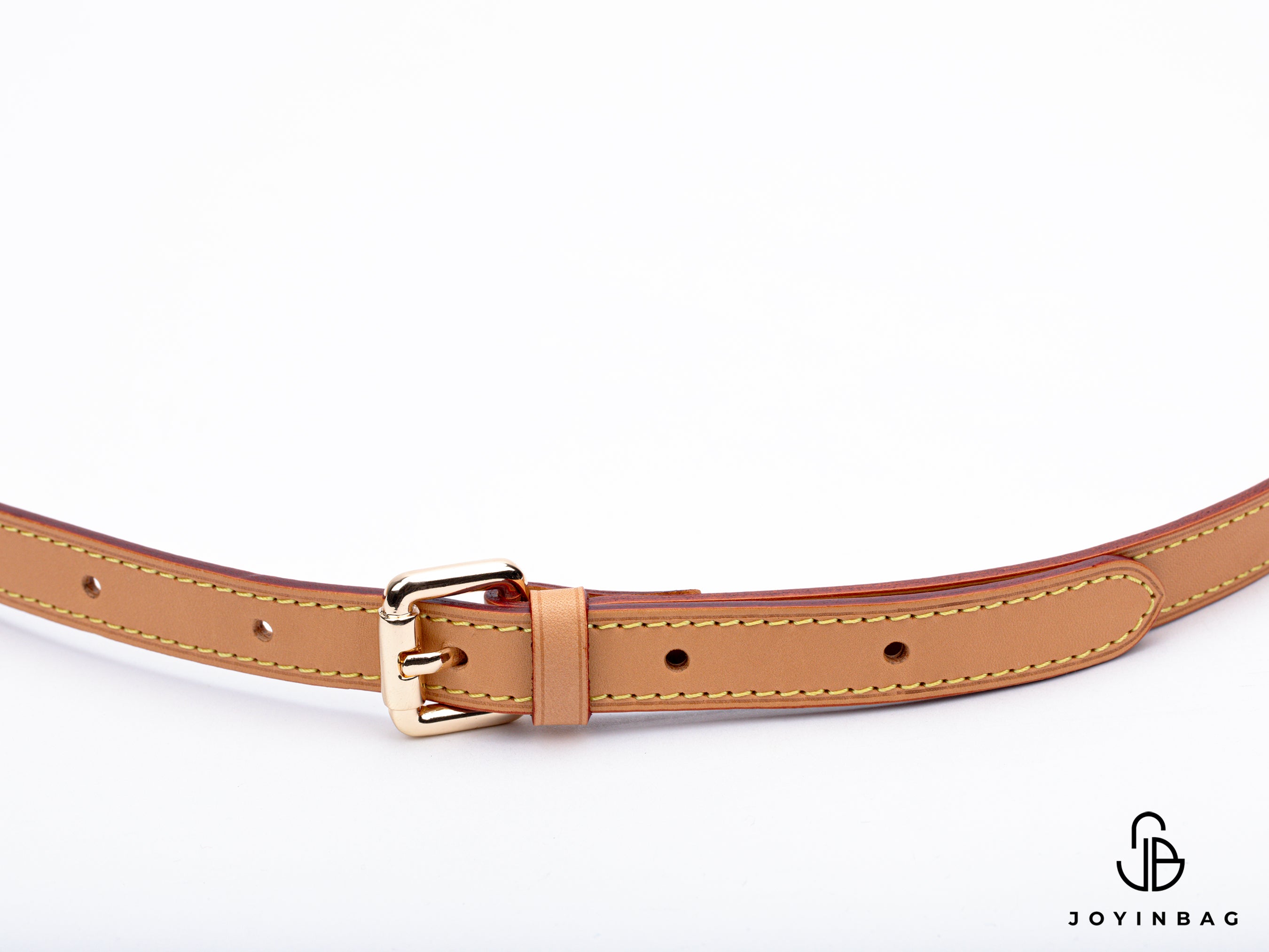 Adjustable honey vachetta strap with clasp closure at both ends.